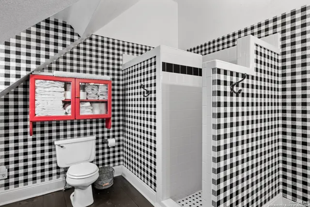 a living room with furniture floor to ceiling window and wooden floor