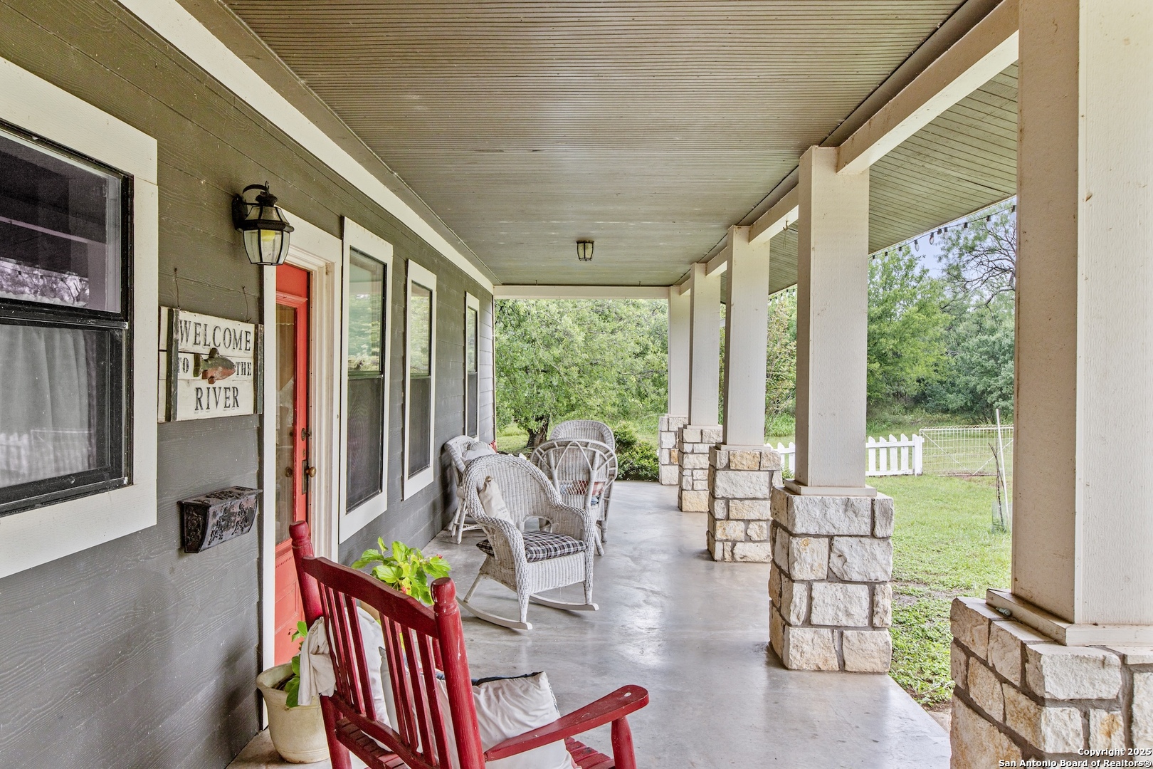 211 Riverside Drive West Llano, TX 78643 - Photo 65 of 74 a living room with furniture floor to ceiling window and wooden floor