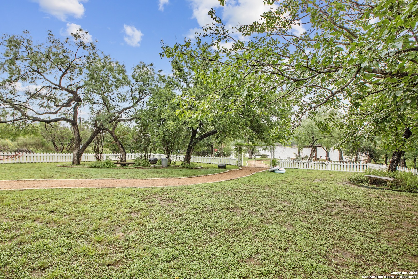 211 Riverside Drive West Llano, TX 78643 - Photo 68 of 74 a view of a house with a big yard and palm trees