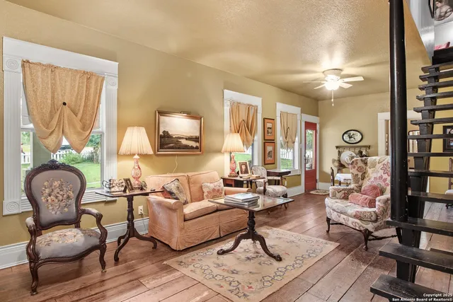 a living room with fireplace furniture and a rug