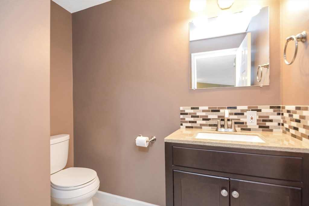 90 Mountain Gate Road, Unit 90 Ashland, MA 01721 - Photo 14 of 29 a bathroom with a sink a toilet and mirror