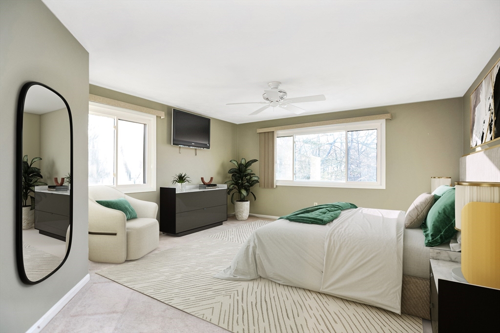 90 Mountain Gate Road, Unit 90 Ashland, MA 01721 - Photo 15 of 29 a bedroom with a bed and a chandelier