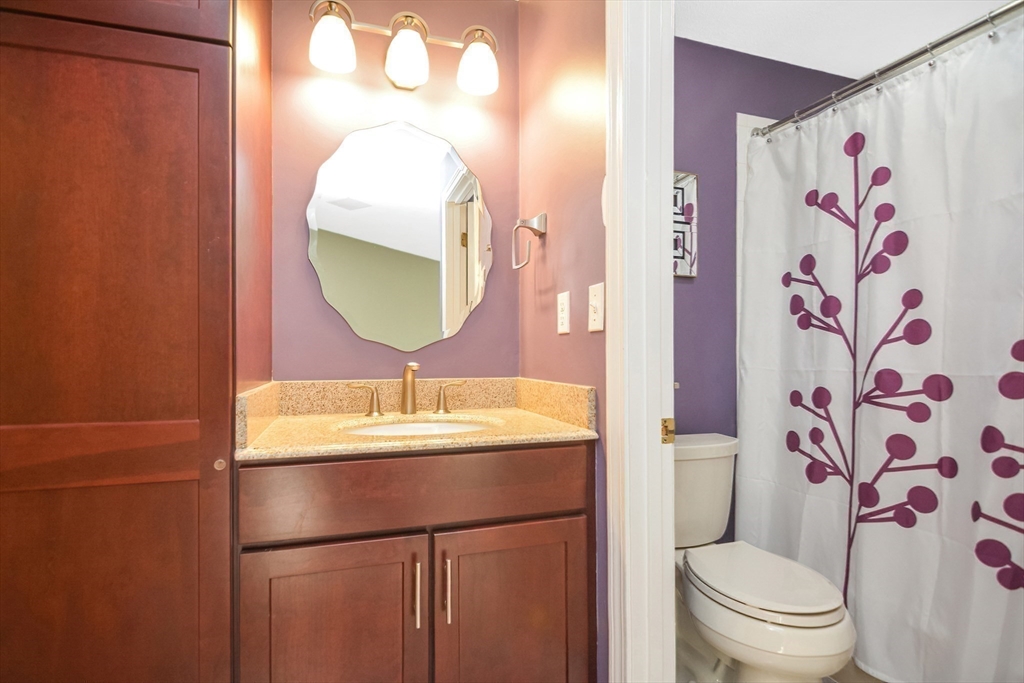 90 Mountain Gate Road, Unit 90 Ashland, MA 01721 - Photo 18 of 29 a bathroom with a sink toilet and mirror