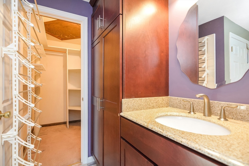 90 Mountain Gate Road, Unit 90 Ashland, MA 01721 - Photo 19 of 29 a bathroom with a granite countertop sink and a mirror