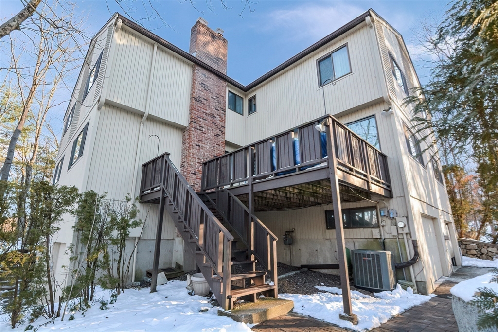 90 Mountain Gate Road, Unit 90 Ashland, MA 01721 - Photo 2 of 29 a view of a house with wooden stairs