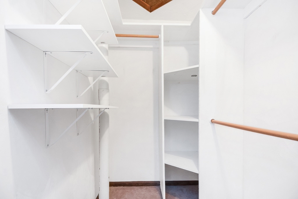 90 Mountain Gate Road, Unit 90 Ashland, MA 01721 - Photo 21 of 29 a view of walk in closet with empty racks