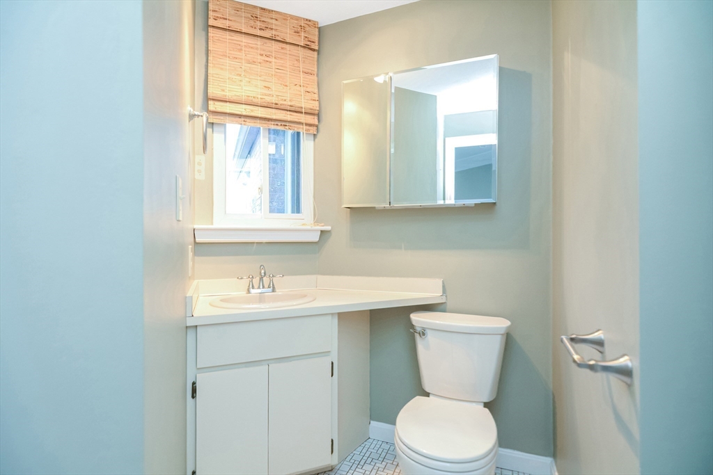 90 Mountain Gate Road, Unit 90 Ashland, MA 01721 - Photo 24 of 29 a bathroom with a toilet sink and mirror