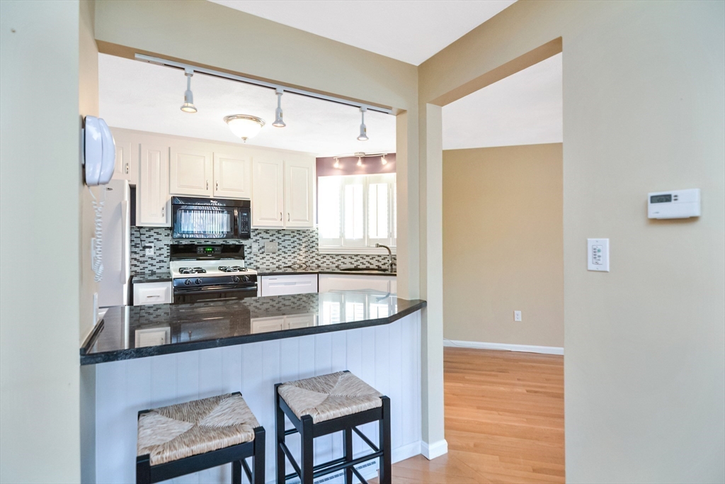 90 Mountain Gate Road, Unit 90 Ashland, MA 01721 - Photo 9 of 29 a kitchen with stainless steel appliances granite countertop a sink refrigerator and microwave