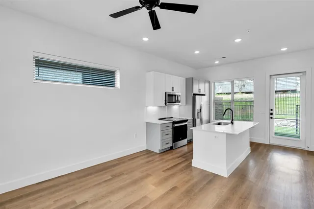 a kitchen with stainless steel appliances a sink stove and refrigerator
