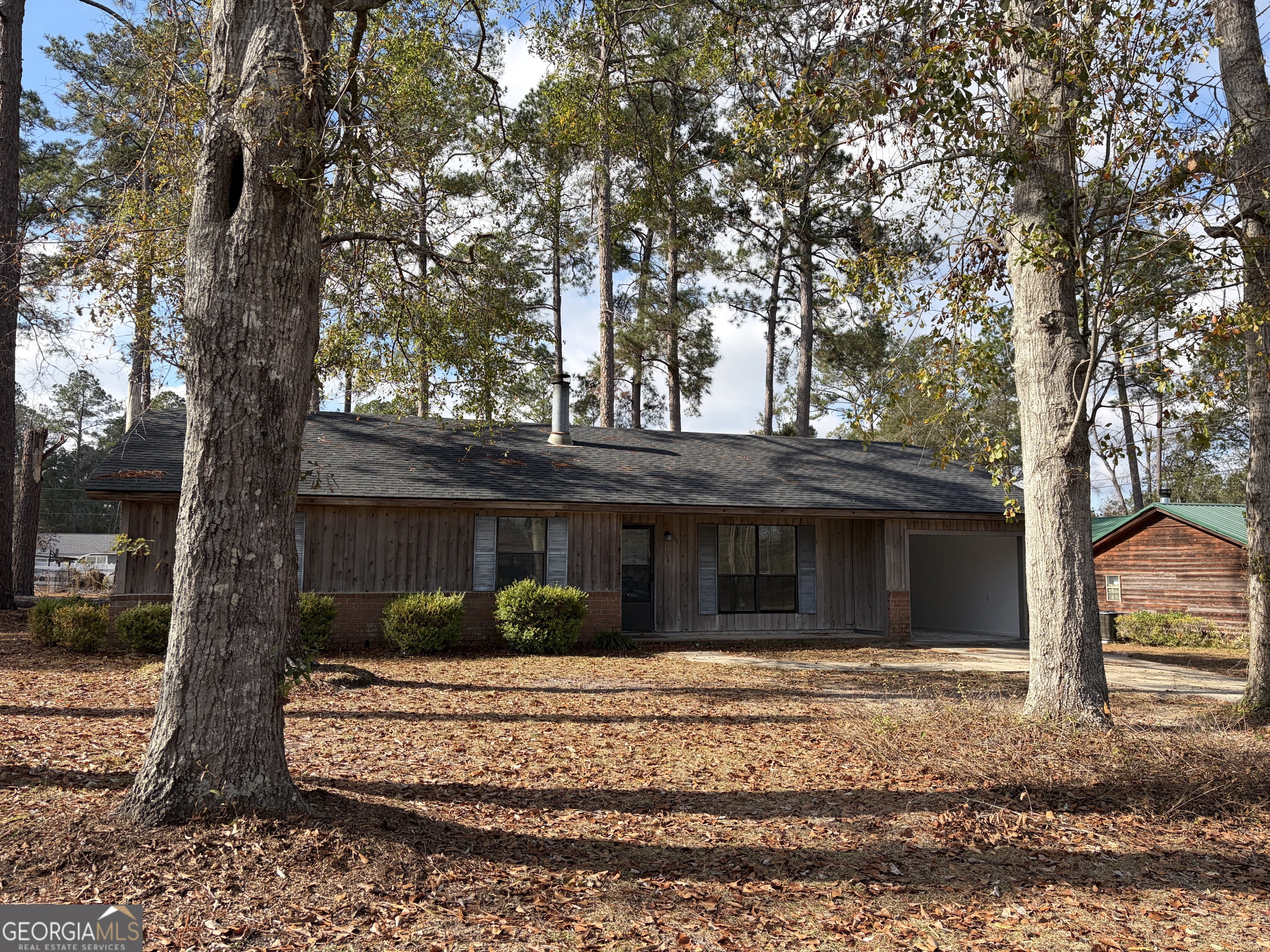 a view of house with a tree in front