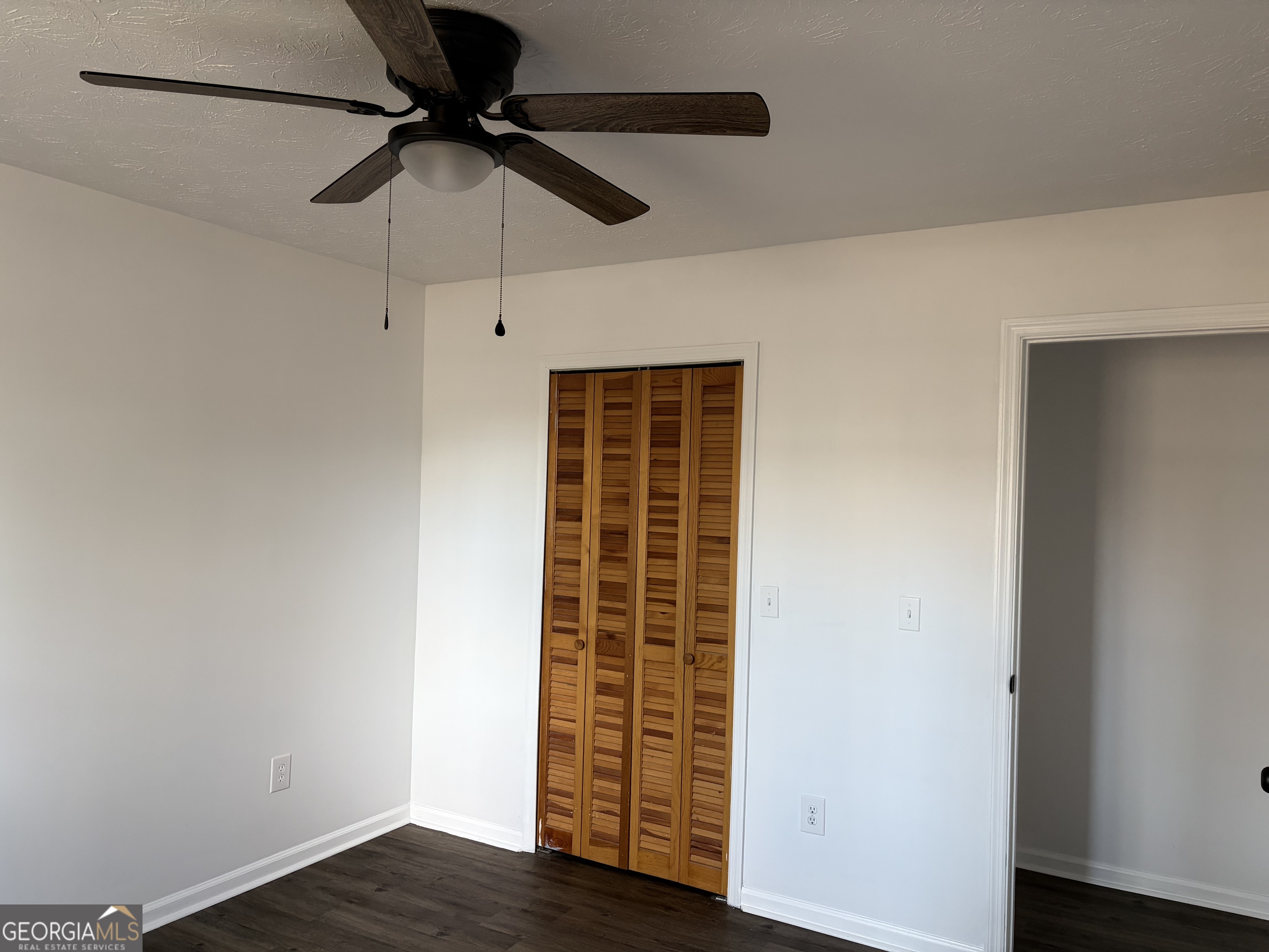 169 Ext N Jefferson Street Lyons, GA 30436 - Photo 16 of 18 a view of an empty room with wooden floor and a window