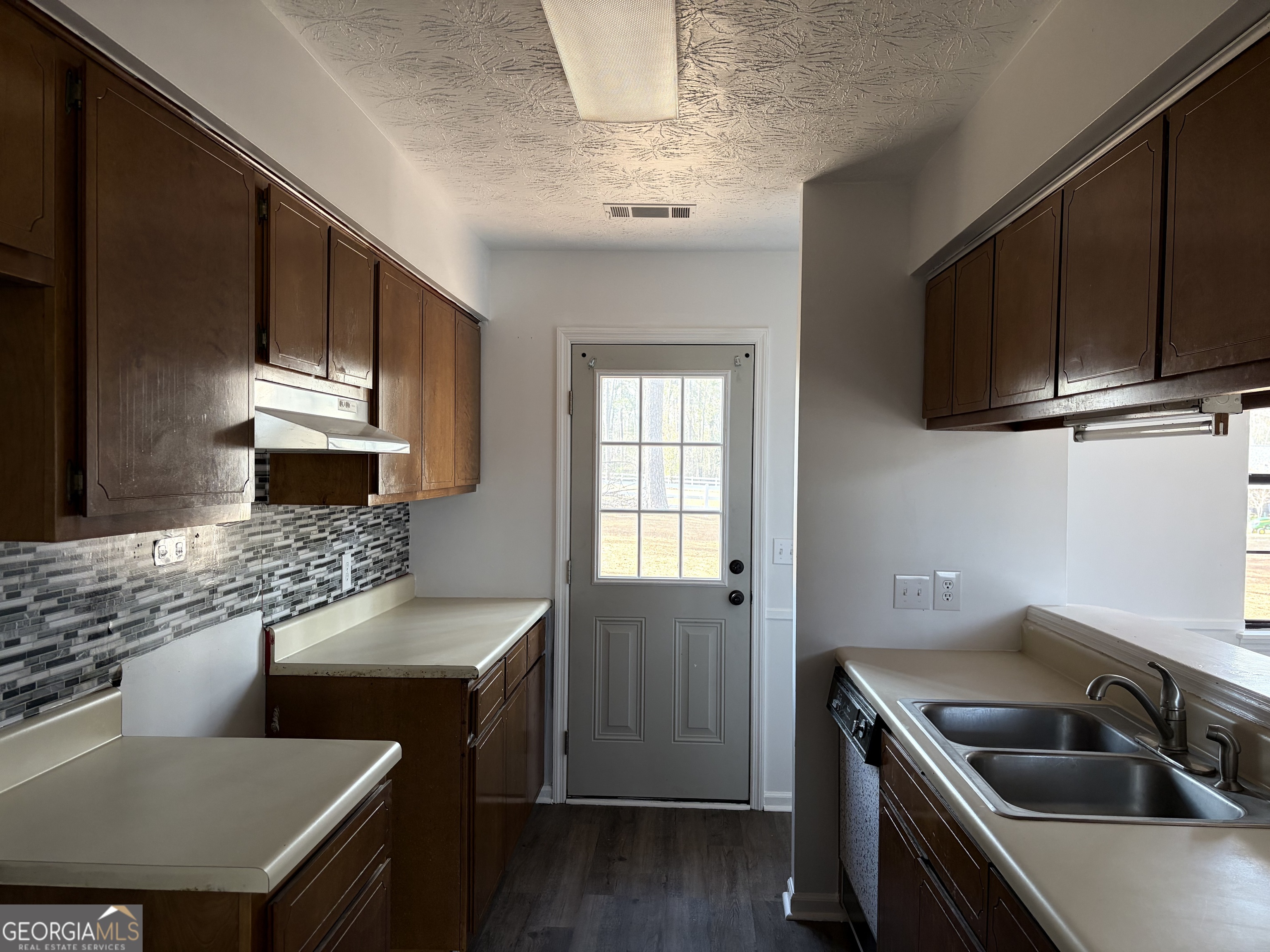 169 Ext N Jefferson Street Lyons, GA 30436 - Photo 6 of 18 a kitchen with a stove a sink and a microwave