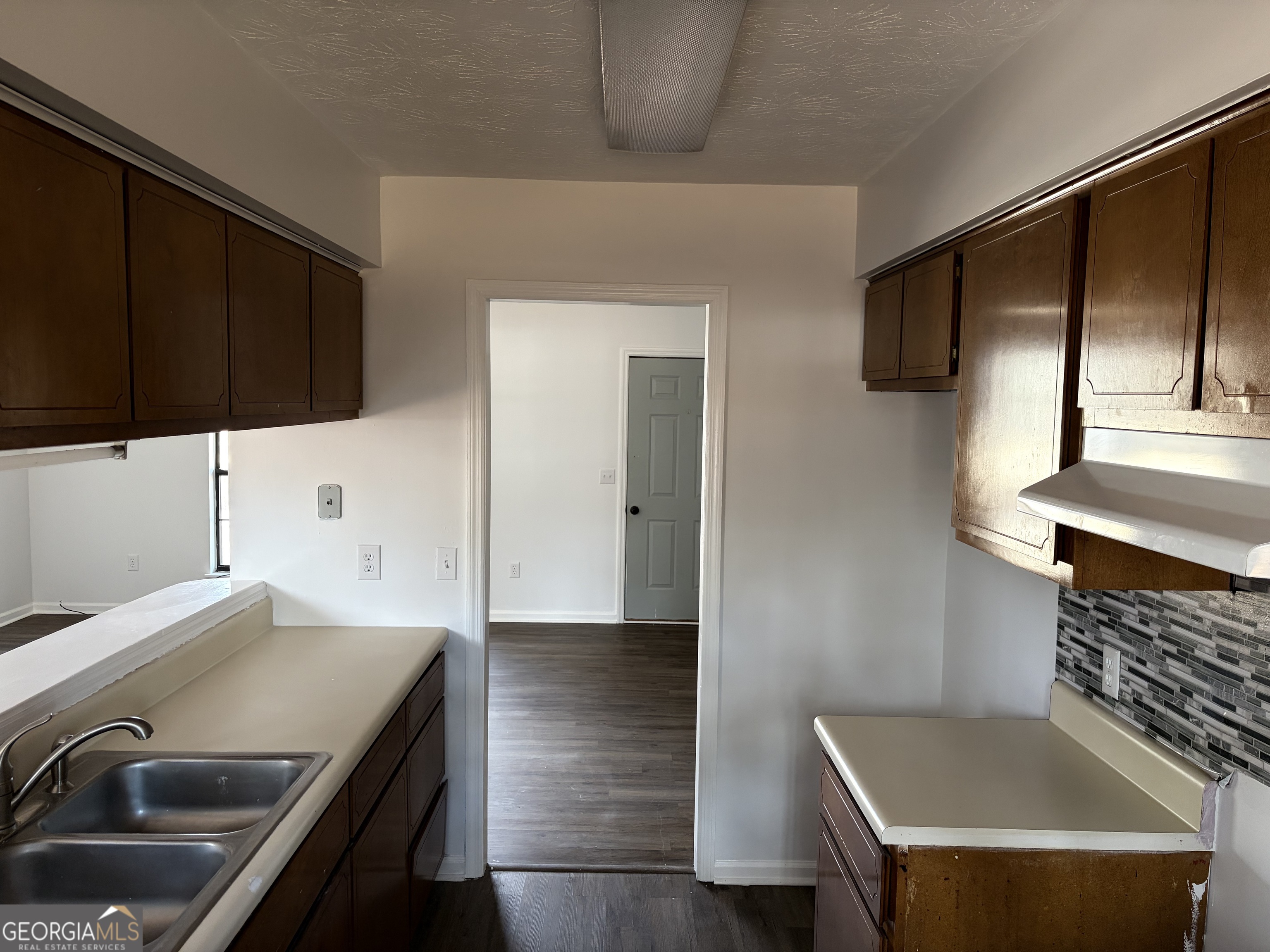 169 Ext N Jefferson Street Lyons, GA 30436 - Photo 7 of 18 a kitchen with a stove and a microwave