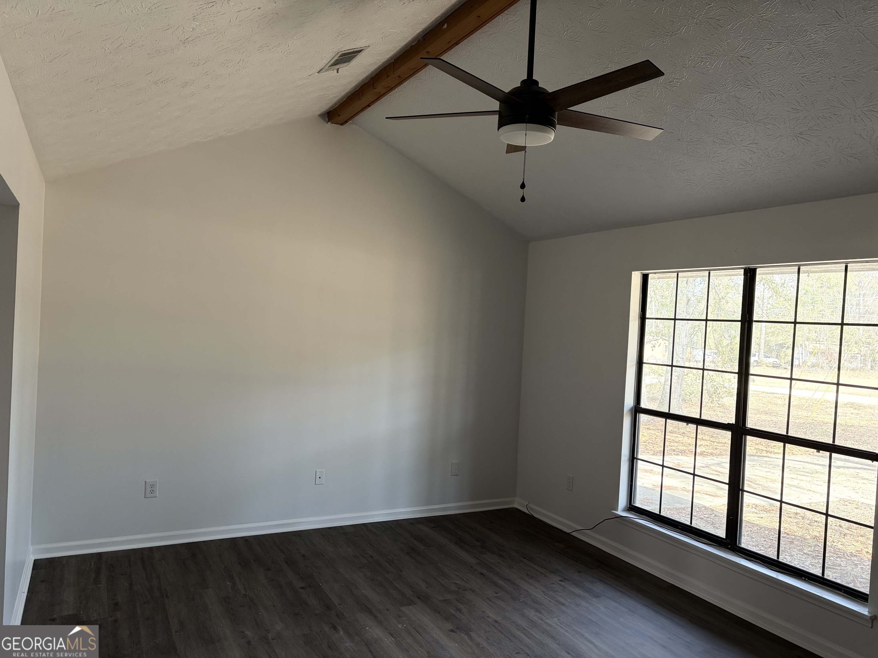 169 Ext N Jefferson Street Lyons, GA 30436 - Photo 8 of 18 wooden floor in an empty room with a window