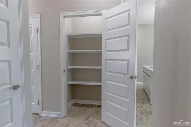 a view of walk in closet with empty racks