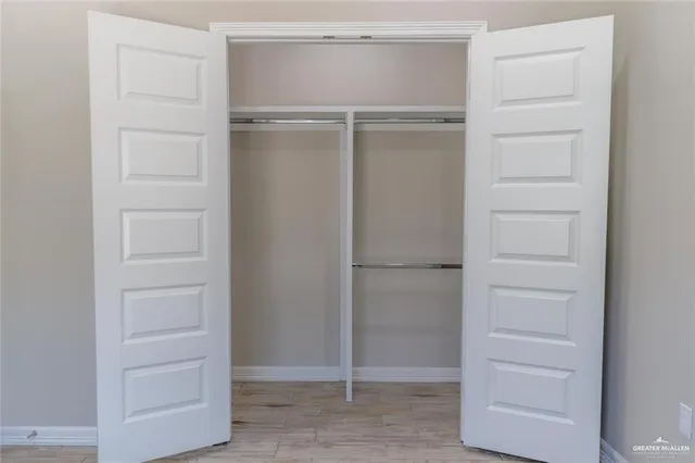 a view of walk in closet with empty racks
