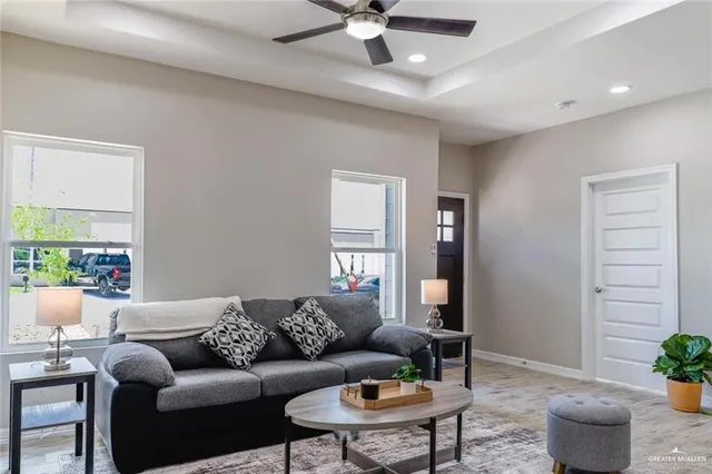 a living room with furniture and wooden floor