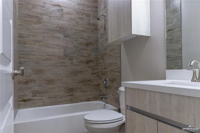 a bathroom with a sink a toilet and bathtub