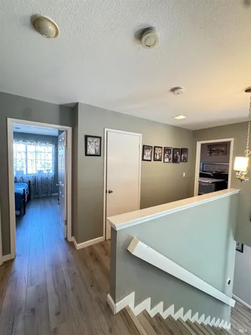 a view of a living room with furniture and wooden floor