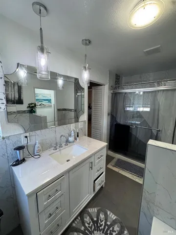 a bathroom with a tub sink and mirror