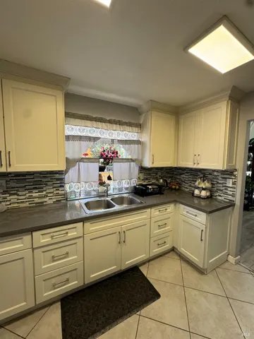 a kitchen with stainless steel appliances granite countertop a sink and a stove