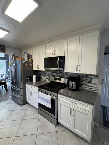 a kitchen with a stove a microwave and refrigerator