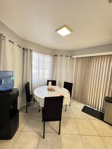 a view of a dining room with furniture and window