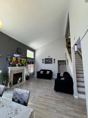a living room with furniture a fireplace and a flat screen tv