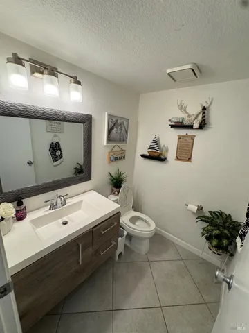 a spacious bathroom with a sink mirror and toilet