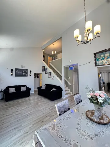 a bedroom with bed and a chandelier