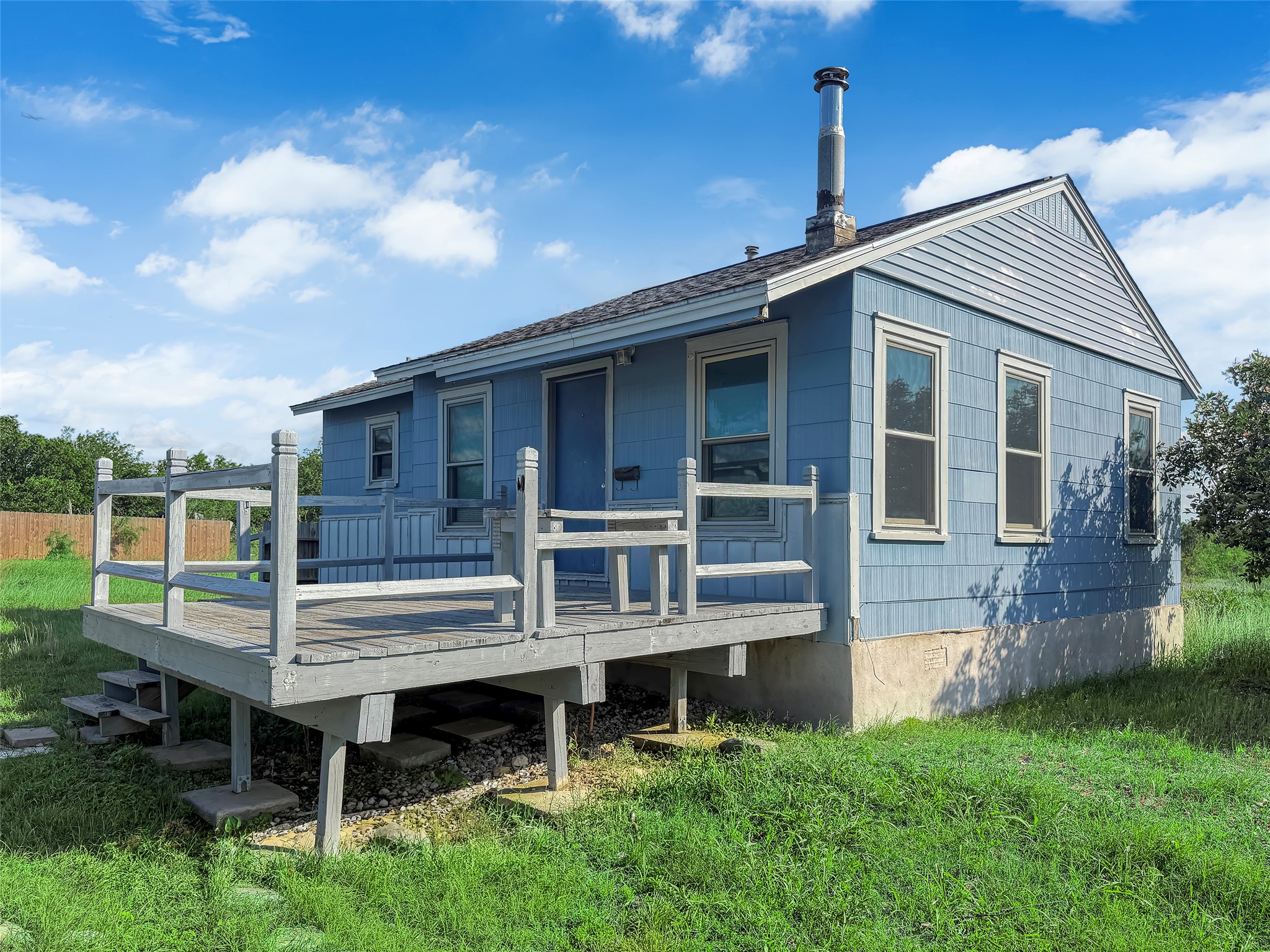 925 Long Hollow Road Dale, TX 78616 - Photo 4 of 26 Light blue siding with white trim accents and a gray shingle roof