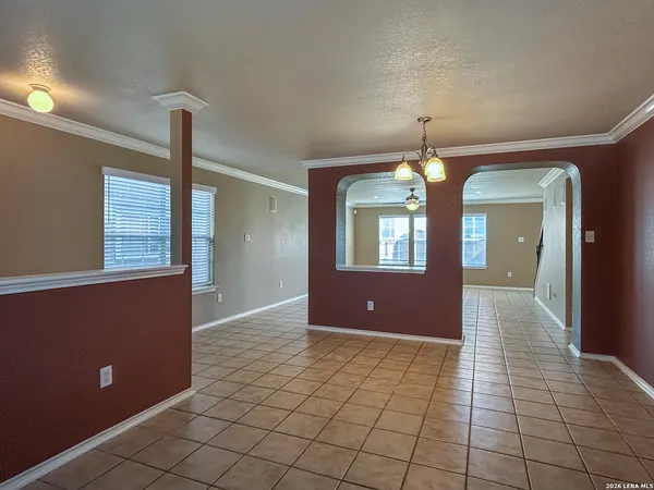 a view of an empty room and window chandelier fan
