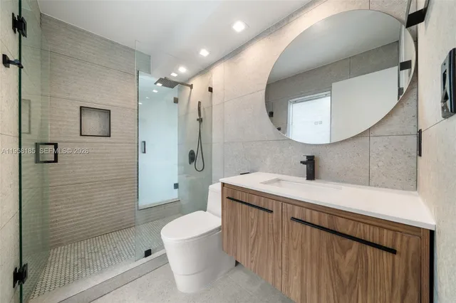 a bathroom with a sink a toilet and shower