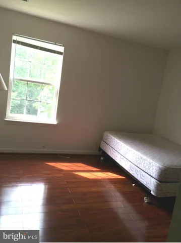 a view of a room with wooden floor and window