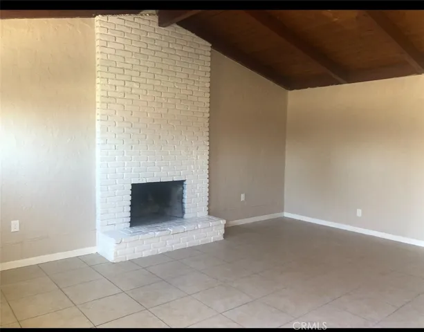 a view of an empty room with a fireplace