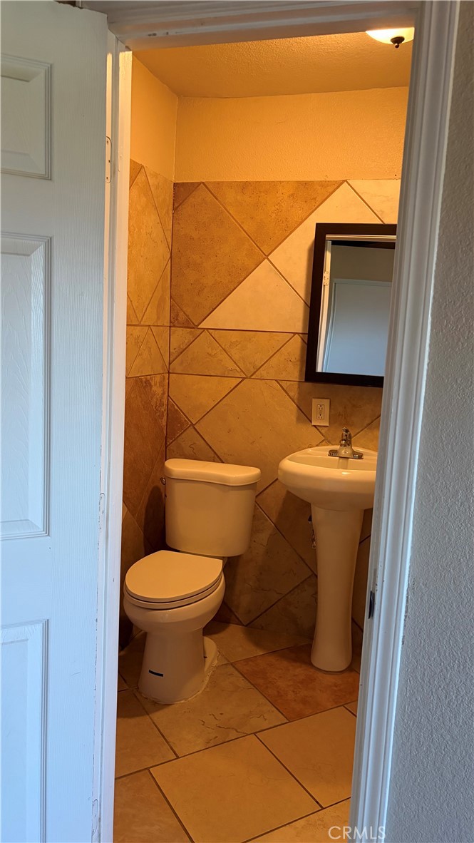 19340 Woodhill Street Rialto, CA 92376 - Photo 7 of 7 a bathroom with a toilet and a sink