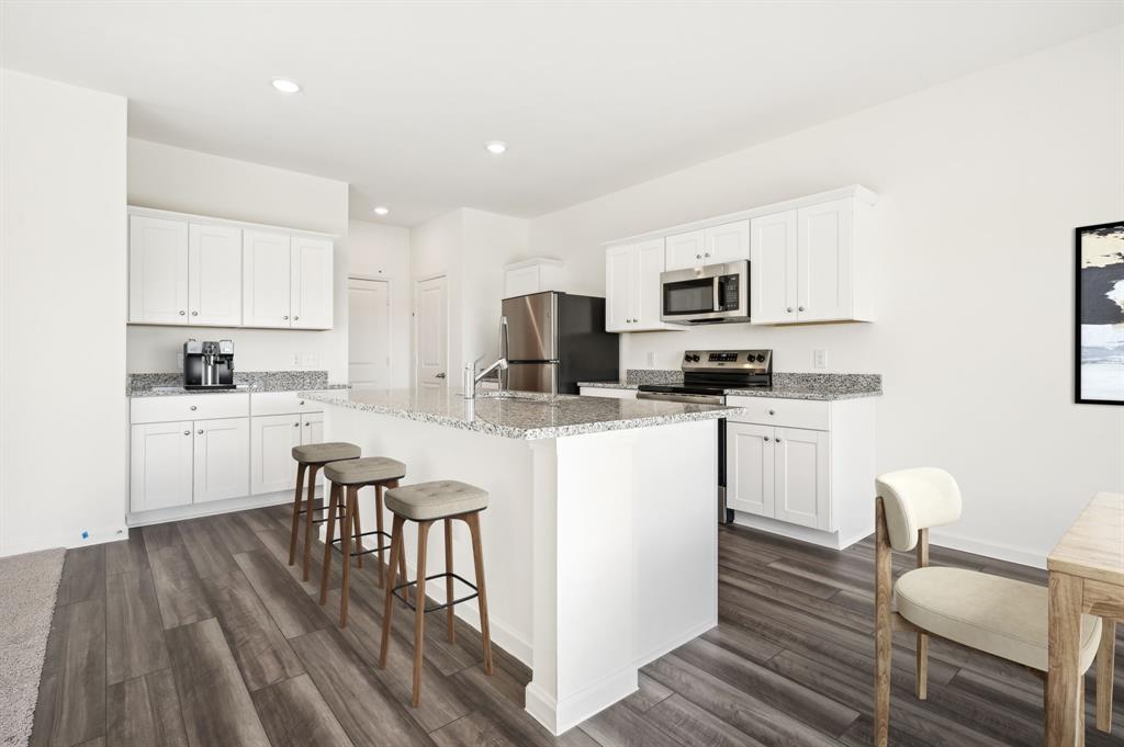 2403 States Street Princeton, TX 75407 - Photo 11 of 39 Kitchen featuring white cabinetry, light stone counters, stainless steel appliances, and recessed lighting