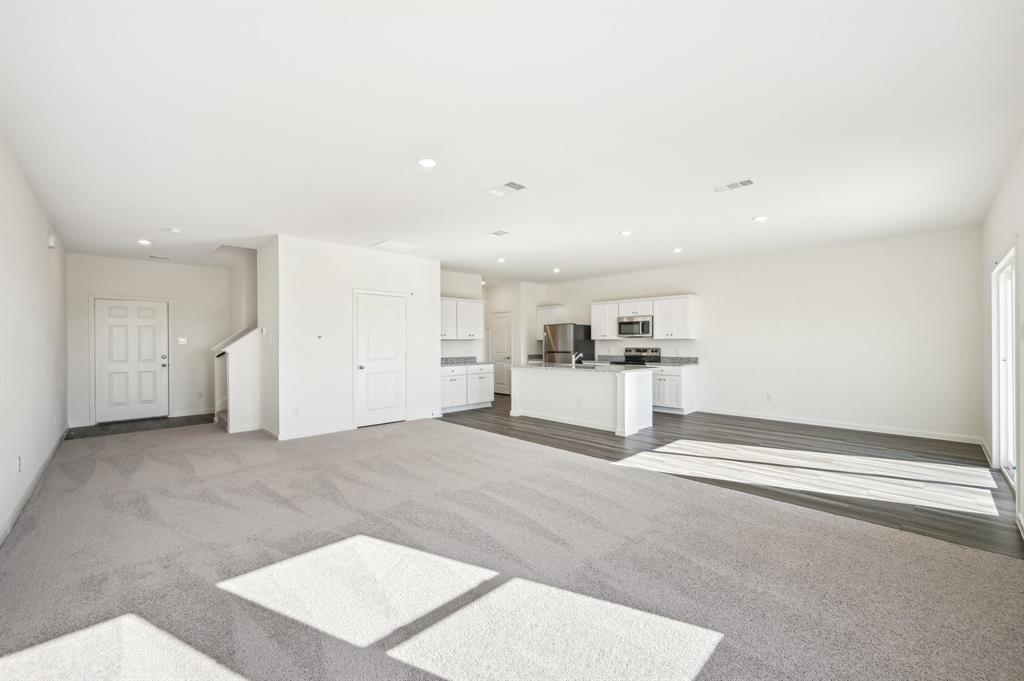 2403 States Street Princeton, TX 75407 - Photo 16 of 39 Unfurnished living room with dark colored carpet and recessed lighting