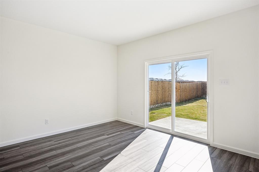 2403 States Street Princeton, TX 75407 - Photo 22 of 39 Spare room featuring baseboards and dark wood-style flooring
