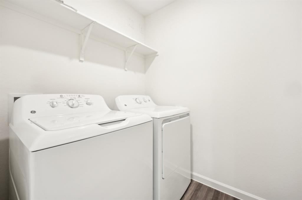 2403 States Street Princeton, TX 75407 - Photo 24 of 39 Laundry room with dark wood-type flooring and washer and clothes dryer