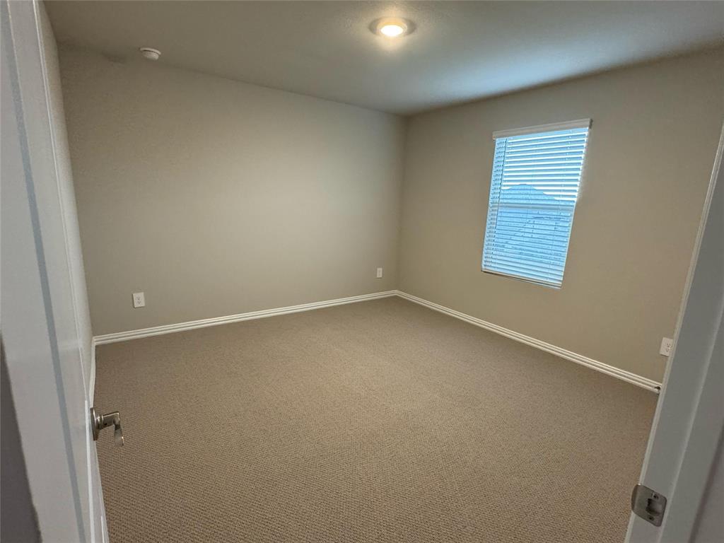 2403 States Street Princeton, TX 75407 - Photo 26 of 39 Empty room featuring carpet and baseboards