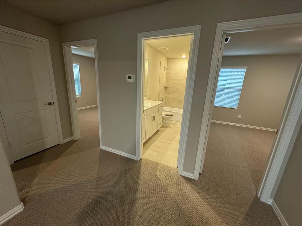 2403 States Street Princeton, TX 75407 - Photo 30 of 39 Hallway with light colored carpet and healthy amount of natural light