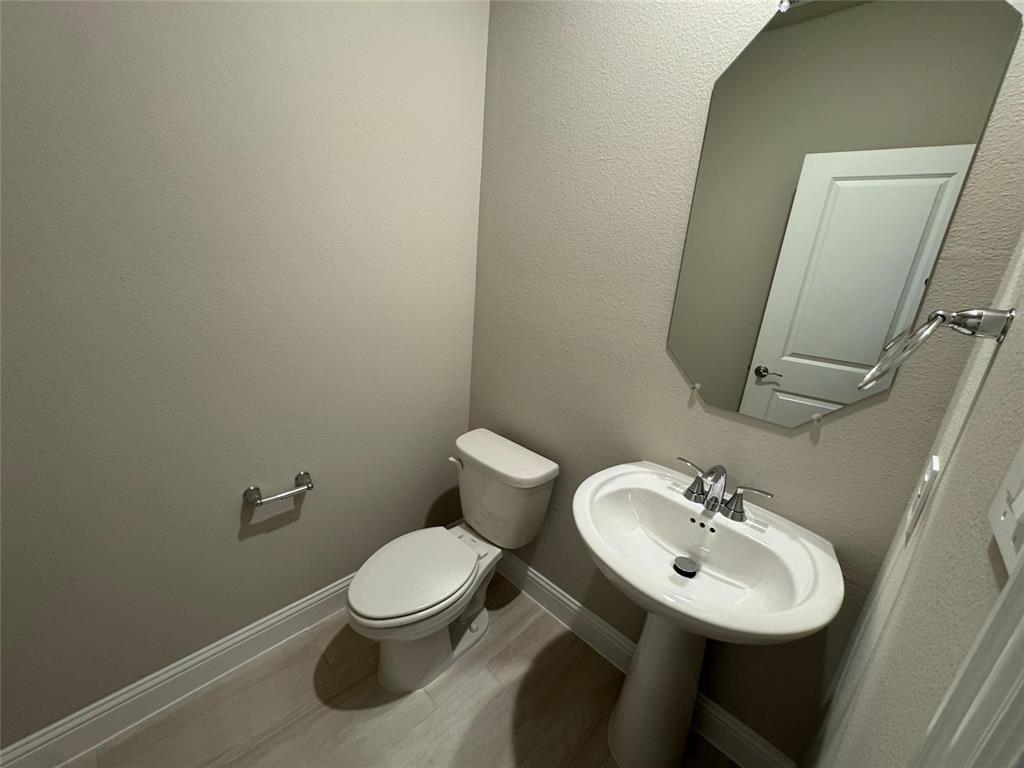 2403 States Street Princeton, TX 75407 - Photo 33 of 39 Half bath with a textured wall and baseboards