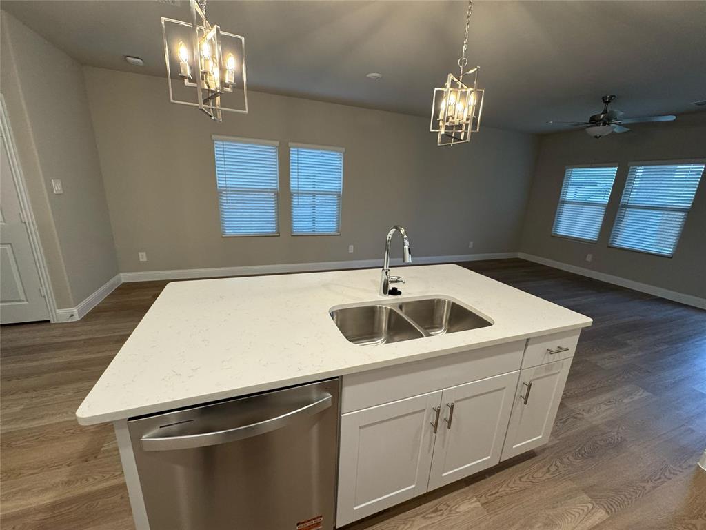 2403 States Street Princeton, TX 75407 - Photo 37 of 39 Kitchen featuring white cabinets, dark wood-style flooring, dishwasher, and a chandelier