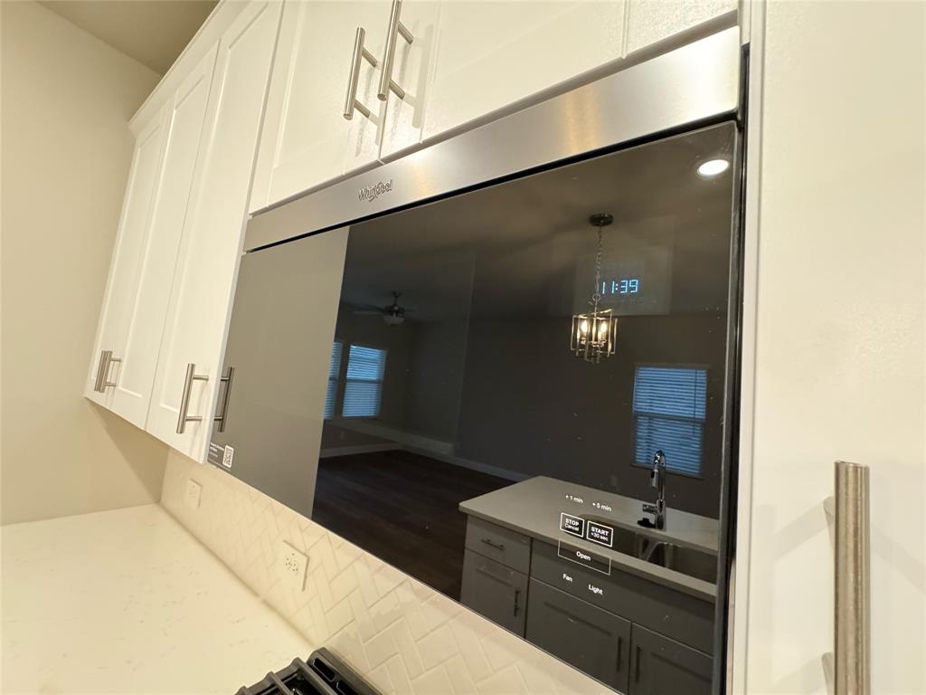 2403 States Street Princeton, TX 75407 - Photo 38 of 39 Kitchen featuring a ceiling fan, hanging light fixtures, a chandelier, gray cabinetry, and dark wood-style flooring