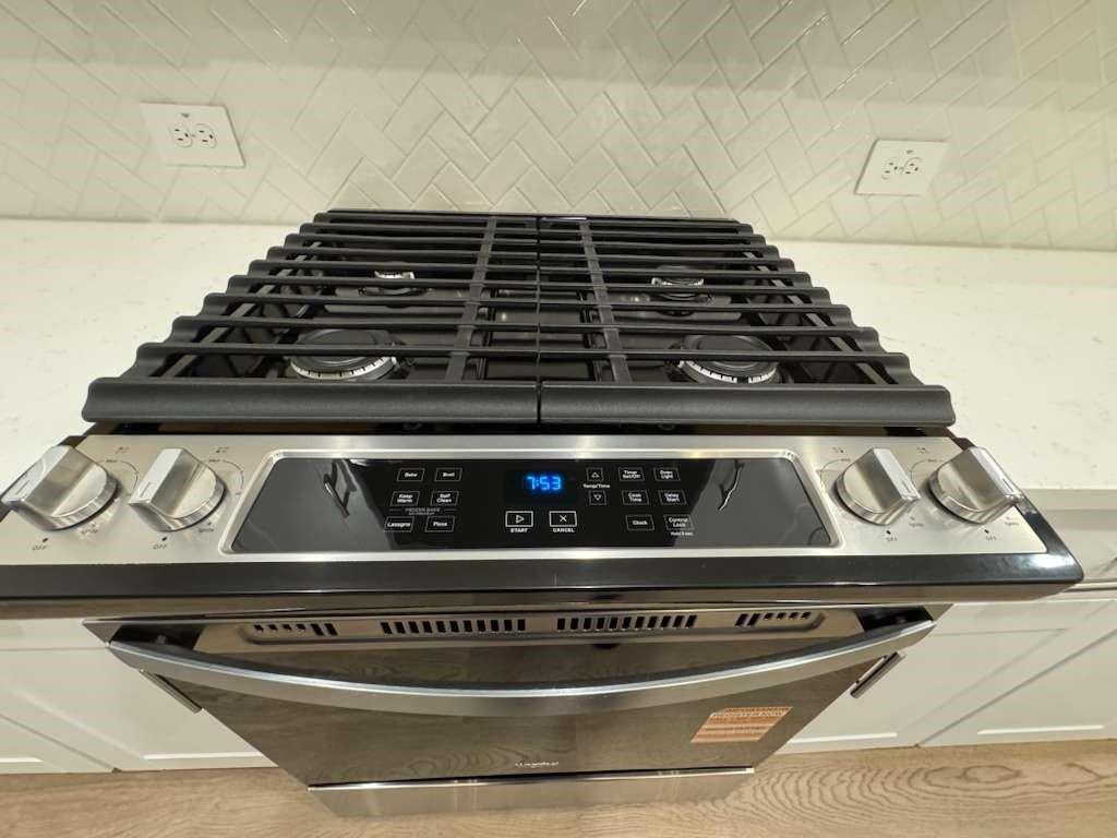2403 States Street Princeton, TX 75407 - Photo 39 of 39 Kitchen view of stainless steel gas range oven and decorative backsplash