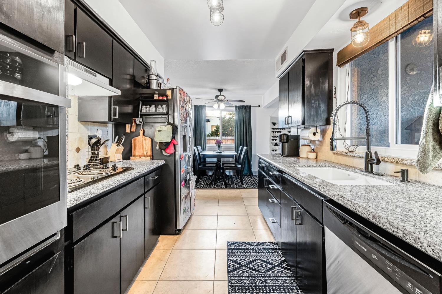 3120 West San Ramon Avenue Fresno, CA 93711 - Photo 11 of 36 a kitchen with stainless steel appliances granite countertop a sink and cabinets