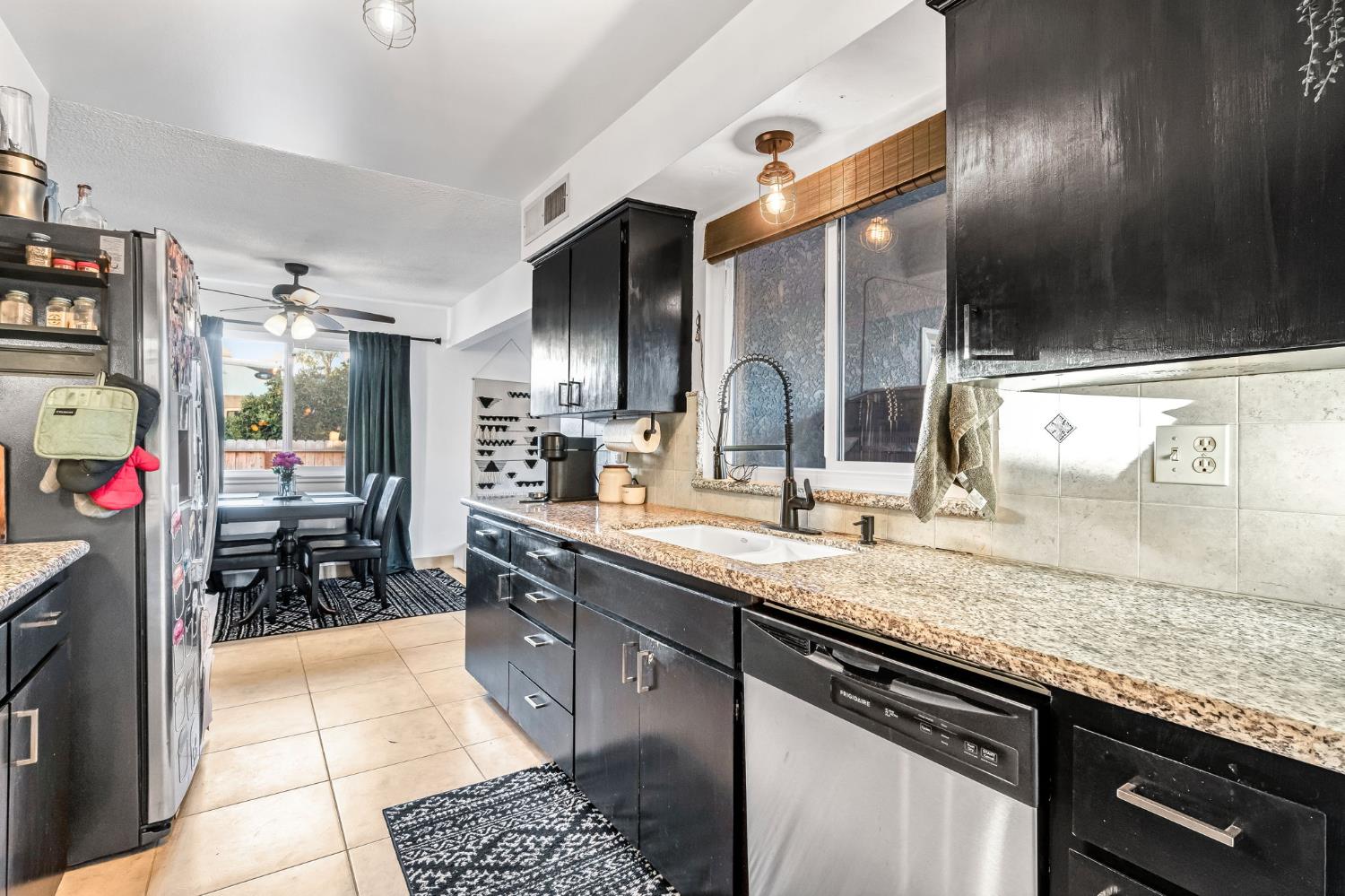 3120 West San Ramon Avenue Fresno, CA 93711 - Photo 12 of 36 a kitchen with stainless steel appliances granite countertop a sink stove and cabinets