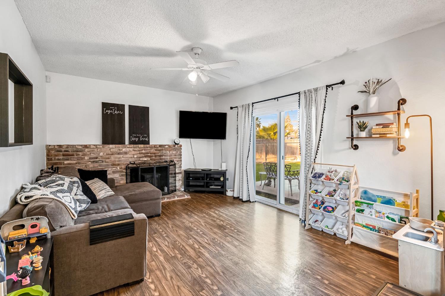 3120 West San Ramon Avenue Fresno, CA 93711 - Photo 15 of 36 a living room with furniture fireplace and flat screen tv