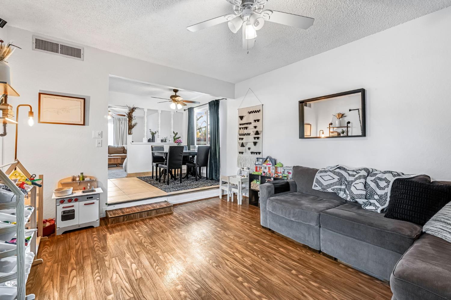 3120 West San Ramon Avenue Fresno, CA 93711 - Photo 16 of 36 a living room with furniture and a chandelier